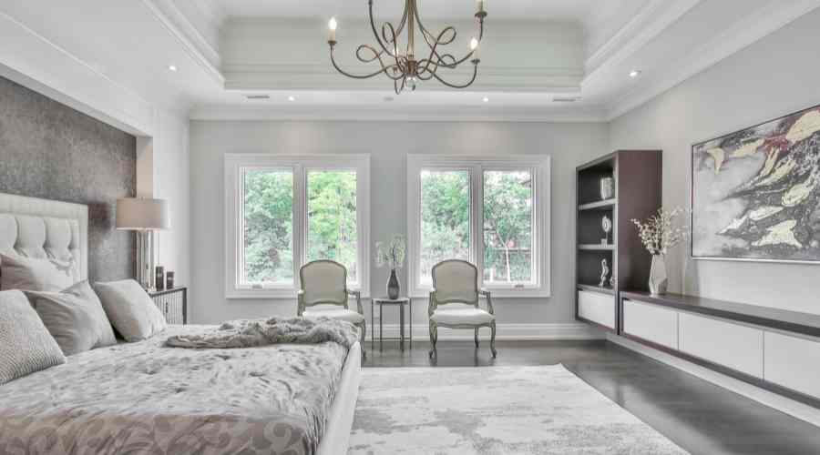 a normal sized chandelier in a big master bedroom