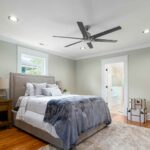 a bedroom with ceiling fan on the ceiling along with recessed light